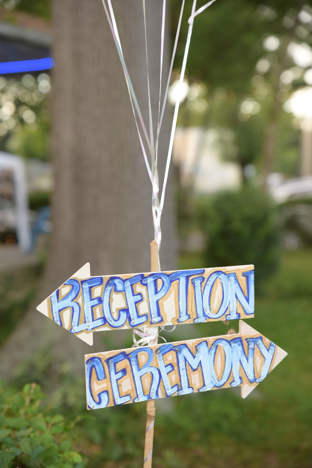 Hand-painted blue reception and ceremony signs with balloon ribbons